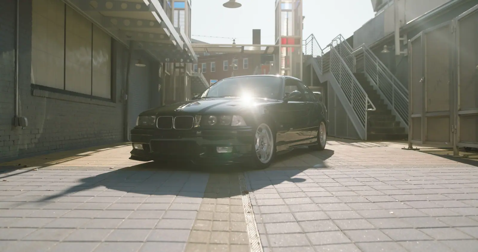 The M3 in an alley, the sun behind it