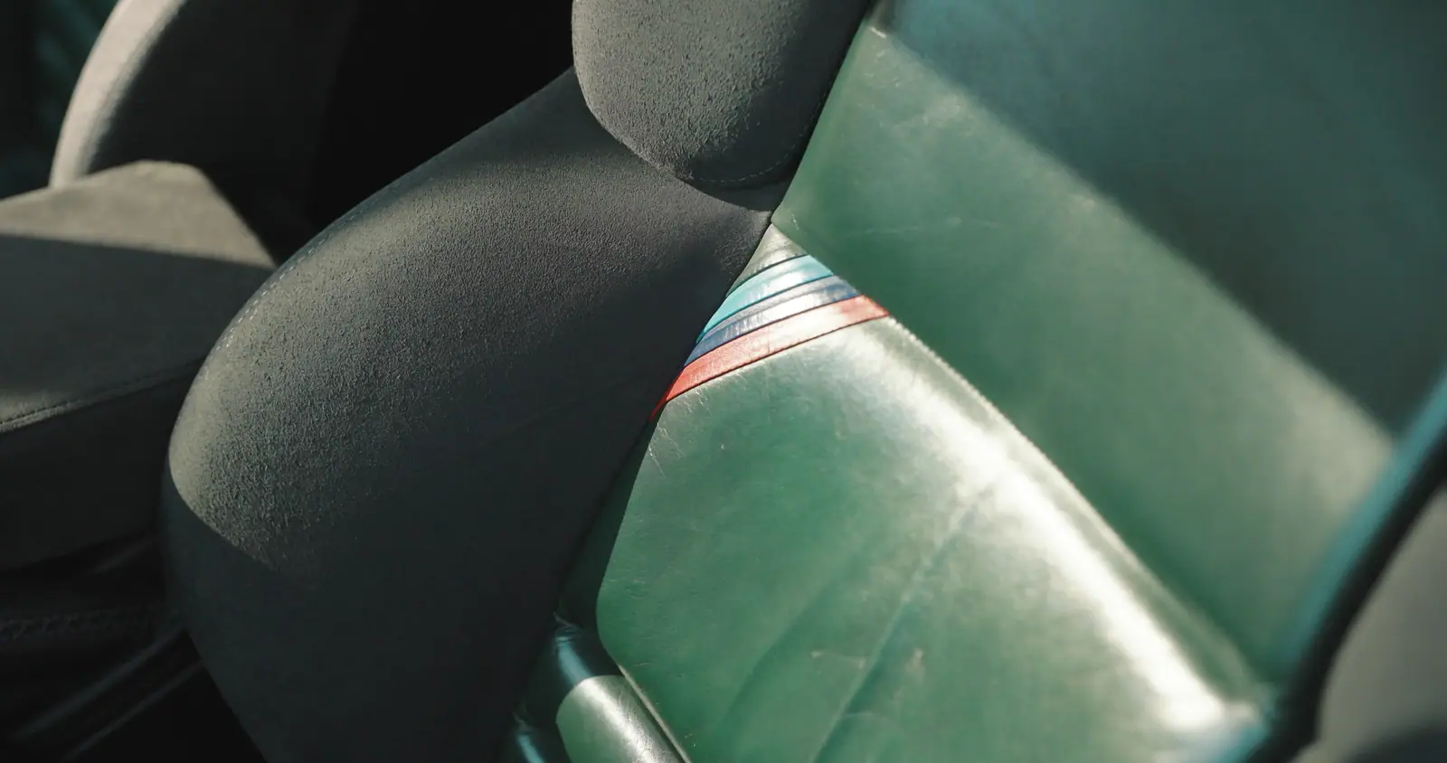The green leather seat and its M stripes