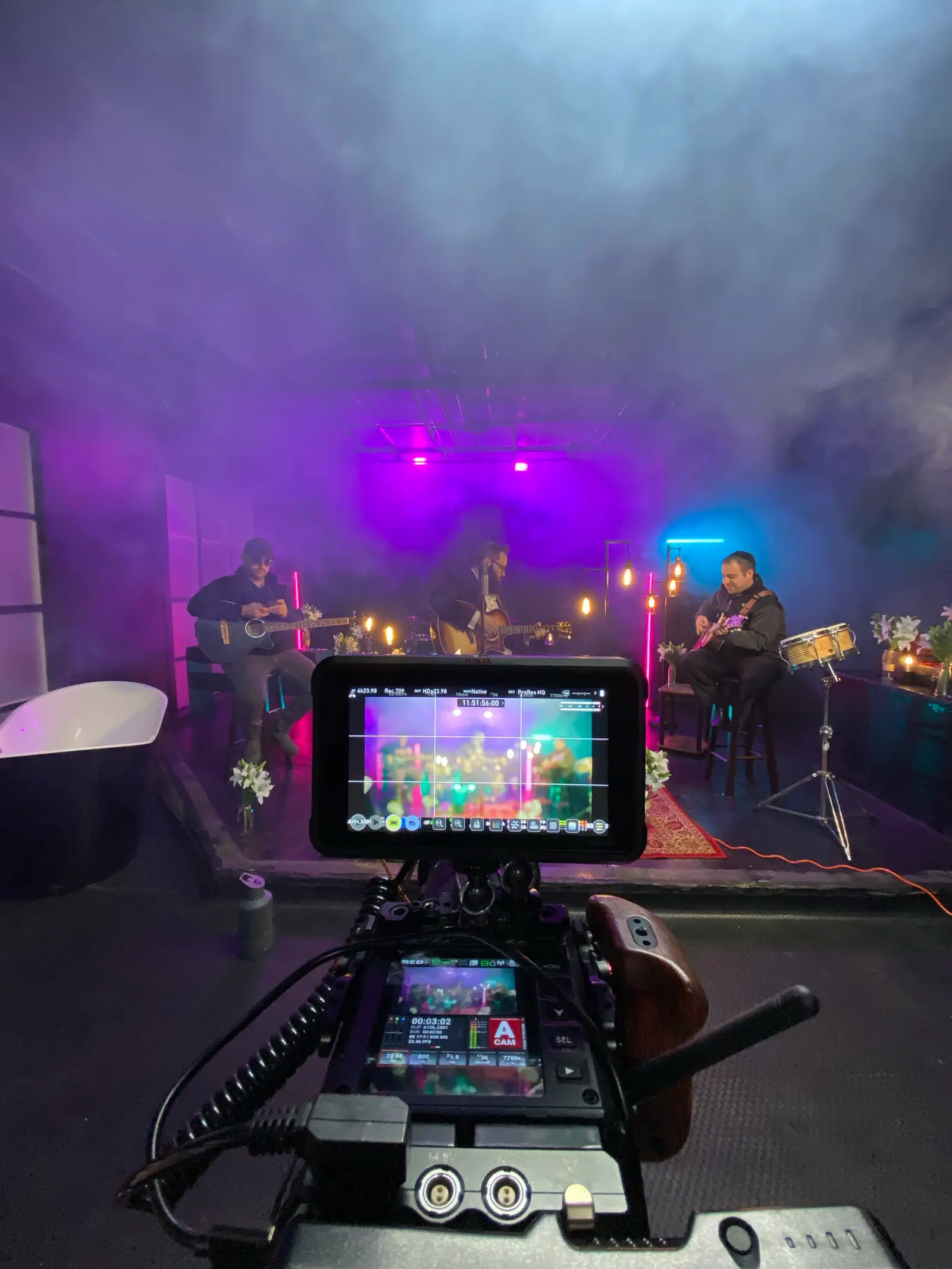 A band session in purple haze and candlelight, framed on the camera monitor