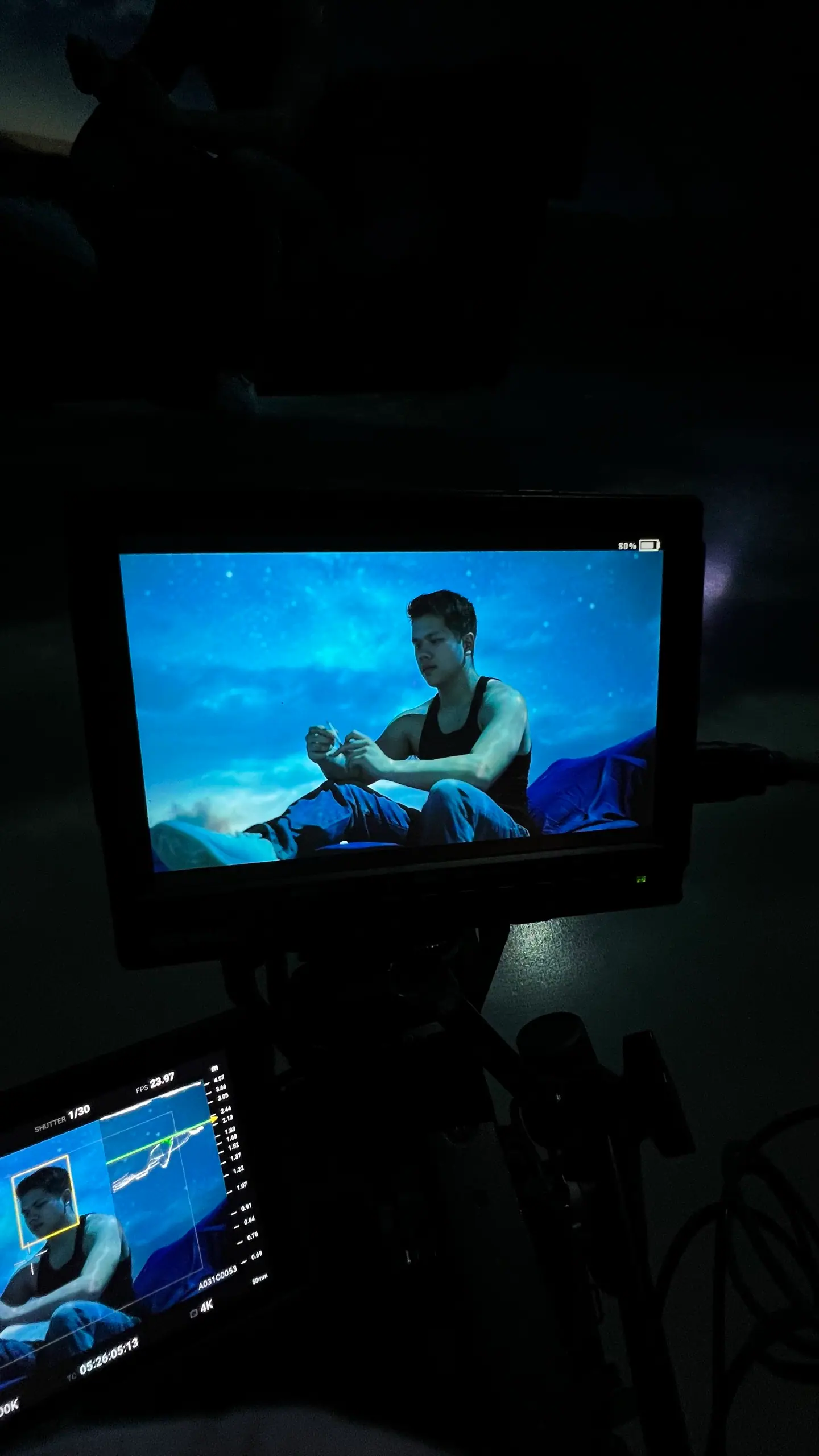 A seated performer framed on a monitor in front of the LED volume