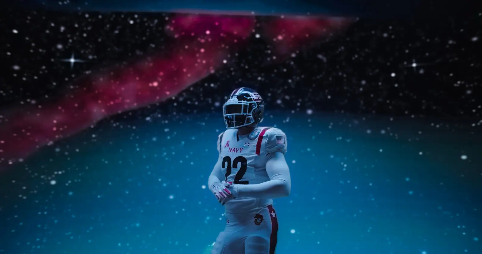 A Navy football player standing in a nebula on the LED wall