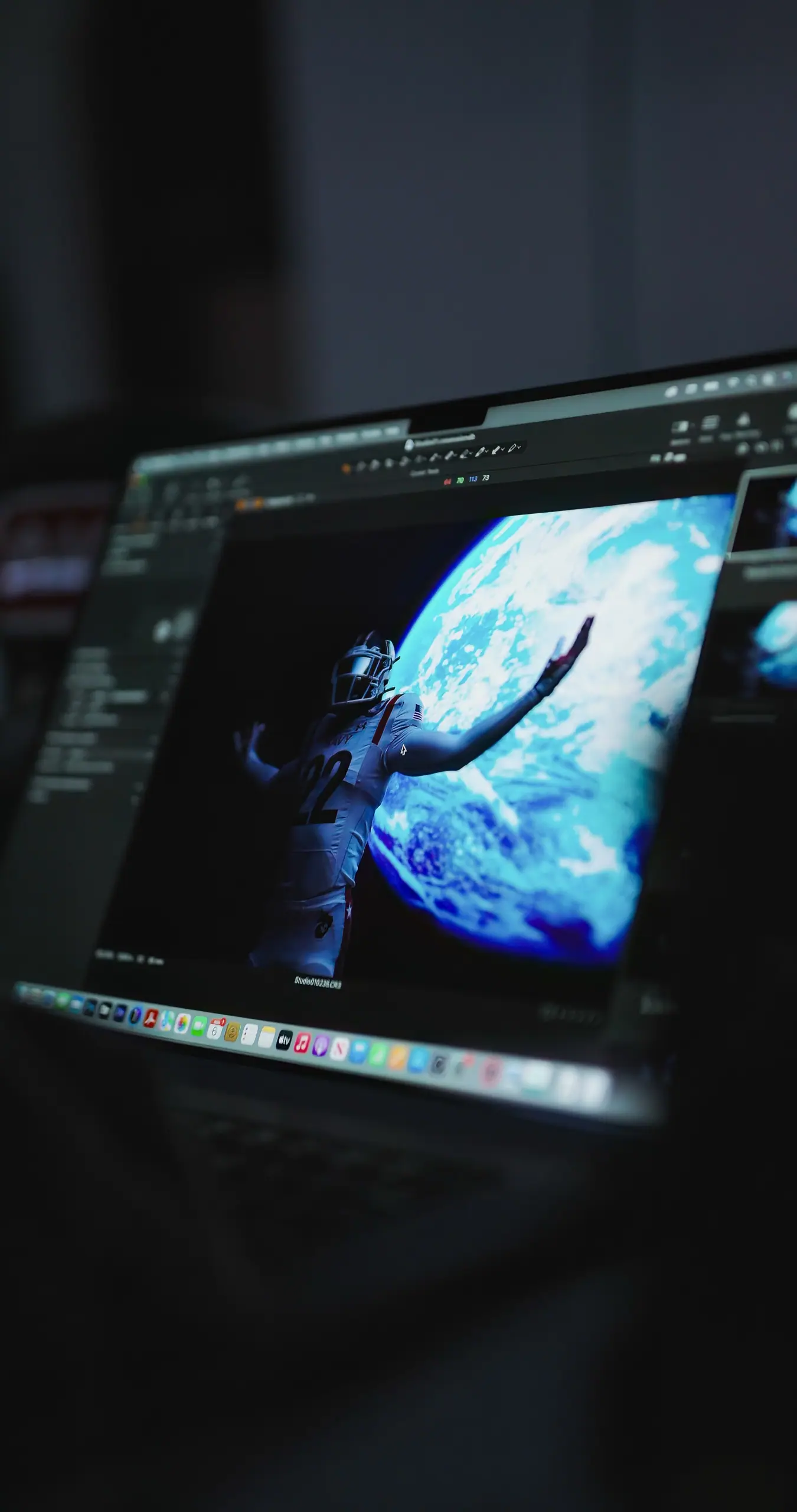A Navy football player against Earth, on a laptop screen in the edit