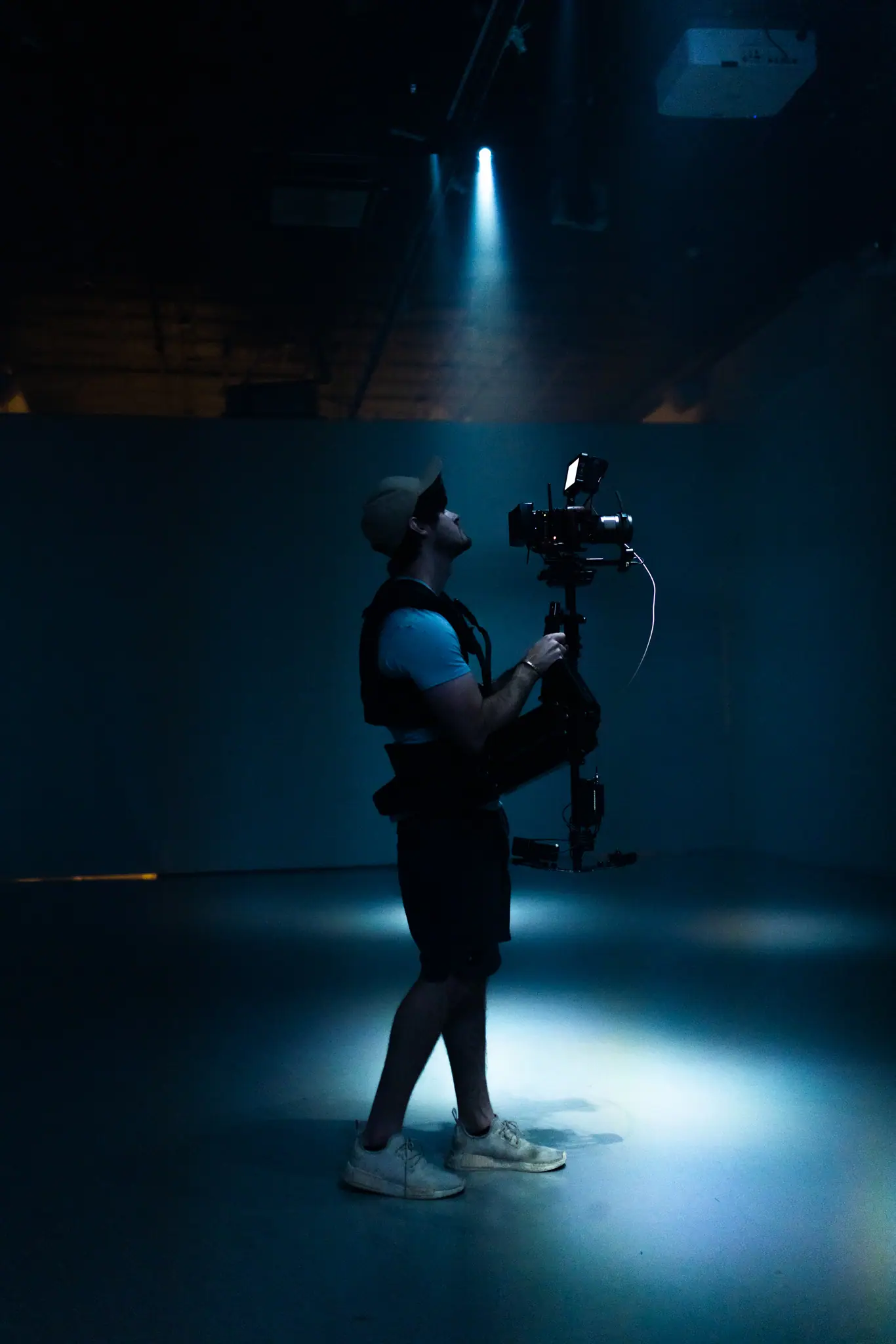Austin Hein on set, operating a Steadicam under a spotlight