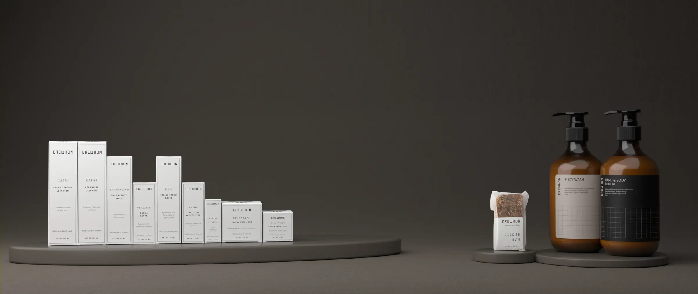 Erewhon's skincare boxes, seeded bar and pump bottles on a dark set
