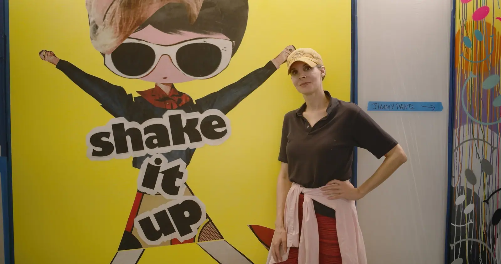 PhoebeNewYork beside her “shake it up” panel