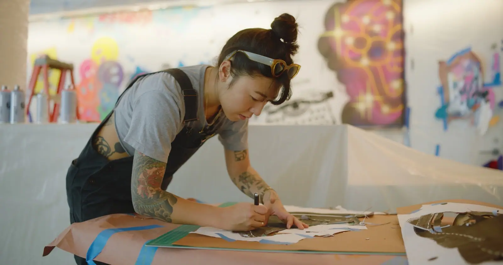 An artist cutting a stencil by hand