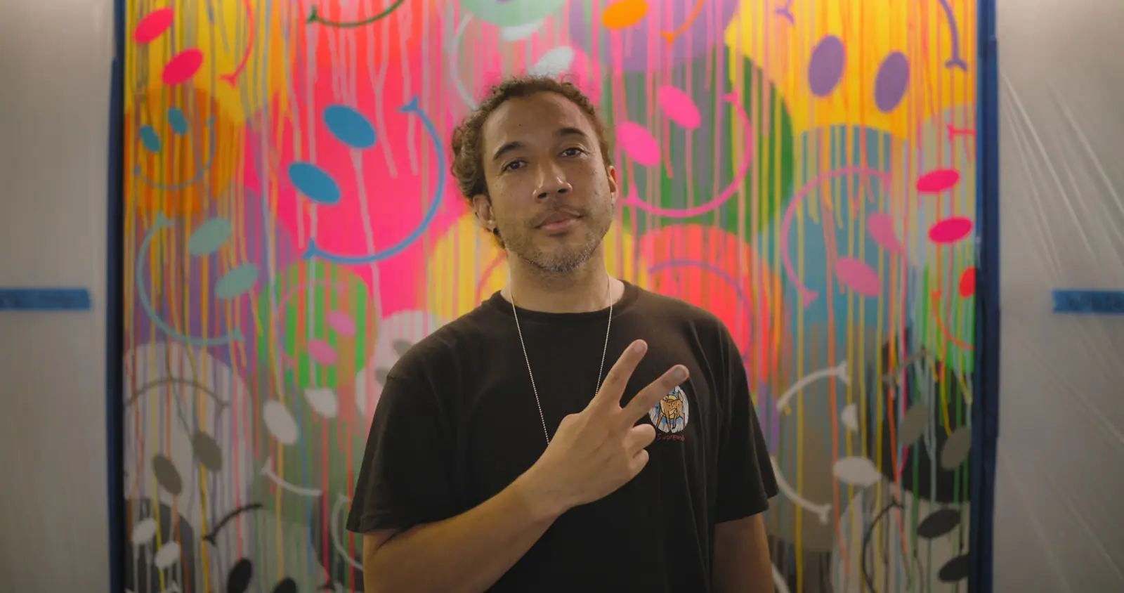 Jimmy Paintz in front of his drip-smiley panel