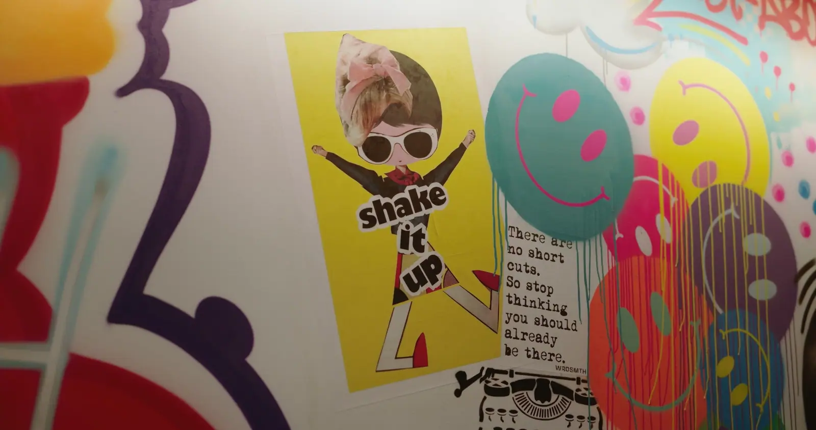 Detail of the collaboration wall: “shake it up”, smileys and a typewriter quote